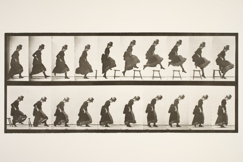 A series of frames showing a woman jumping over a stool